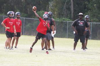 Fort White quarterback Chance Johnson throws a pass during Monday’s practice. (MORGAN MCMULLEN/Lake City Reporter)