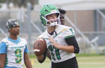 Suwannee quarterback Haigen Johnson drops back to pass during practice on Monday. (JAMIE WACHTER/Lake City Reporter)