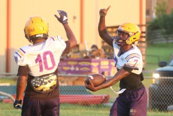 Columbia receiver Kyren Caldwell (right) celebrates with receiver Antonio Days after scoring a touchdown on a long catch-and-run during Monday’s practice. (JORDAN KROEGER/Lake City Reporter)