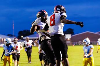 Fort White receiver Jakori Robinson (8) celebrates with receiver Brandon Robinson following a touchdown against Chiefland on Friday. (JACK HOWDESHELL/Lake City Reporter)