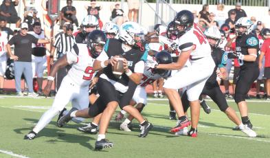 Fort White defensive linemen Josiah Harmon (9) and Cillian Sheehan (40) chase after Providence quarterback Andrew Posey during last Friday’s Kickoff Classic. (MORGAN MCMULLEN/Lake City Reporter)