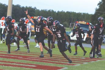 Fort White safety Marvion Wallace (2) celebrates with his teammates after his first interception return for a touchdown against Eastside on Friday. (MORGAN MCMULLEN/Lake City Reporter)