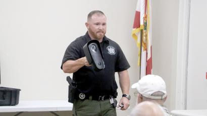 Suwannee County Sheriff’s Office Investigator Jacob Williamson shows nearly 30 people at the Suwannee River Regional Library’s Live Oak branch a Flock camera during Monday’s community meeting. (MORGAN MCMULLEN/Lake City Reporter)