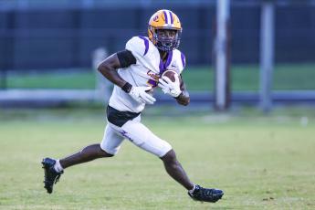 Columbia receiver Kyren Caldwell, a 3-star recruit who is committed to Maryland, turns up the field after a catch against Oakleaf during the Kickoff Classic on Aug. 14. (GARY LLOYD MCCULLOUGH/Special to the Reporter)