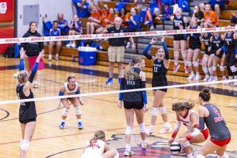 Branford middle blocker Raelea Bradow (6) looks back as her block of Lafayette hitter Sophia Kendrick's (8) attack hits the court Thursday night. (JACK HOWDESHELL/Lake City Reporter)
