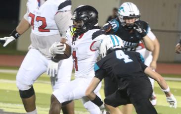 Fort White running back John'l Lawson runs by Providence defensive back Malachi Baughman on Friday night. (MORGAN MCMULLEN/Lake City Reporter)