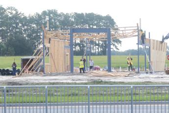 A construction crew works on rebuilding the frame to a new Zaxby’s restaurant Friday morning at Cornerstone Crossing. It’s set to open Nov. 16. (JAMIE WACHTER/Lake City Reporter)