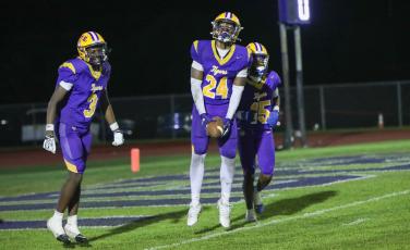 Columbia defensive end Jae’quan Wilson (24) celebrates with defensive back Montenrrence Williamson (3) and defensive back Chris Austin (15) after recovering a fumble for a touchdown against Madison County on Friday. (BRENT KUYKENDALL/Lake City Reporter)