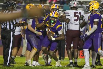 Columbia defensive end Mikel Morgan comes out of the pile after intercepting a pass against Madison County on Friday. (BRENT KUYKENDALL/Lake City Reporter)