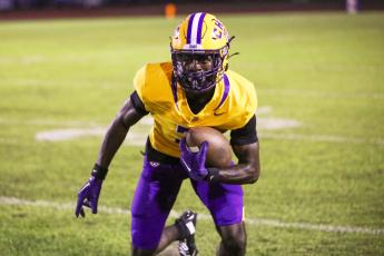 Columbia receiver Kyren Caldwell turns upfield after a catch against Riverside last Friday. (BRENT KUYKENDALL/Lake City Reporter)