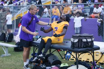 Columbia receiver Kyren Caldwell is attended to by the team trainer after spraining his ankle during last week’s win over Lakewood. (BRENT KUYKENDALL/Lake City Reporter)