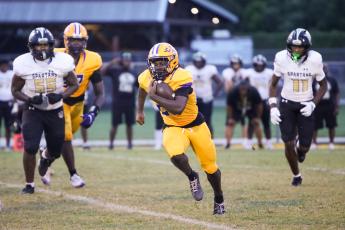 Columbia running back Jerome Horne gets around the corner of the Lakewood defense for a gain on Friday. (BRENT KUYKENDALL/Lake City Reporter)