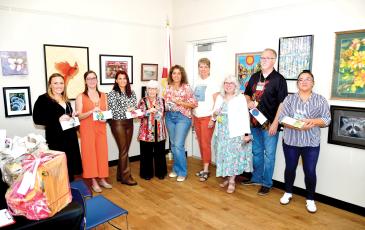 Winners in the Autum ArtFest, which is hosted by the Live Oak Artists Guild, Rachel Budwick (from left), April Phinazee, Jennifer Houston, Anda Chance, Mabel Gonzalez, Sharon Hester, Vaster Fryar, George Fryar and Mariena Craig. (ROB WOLFE/Lake City Reporter)