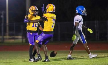 Columbia receiver Antonio Days (10) celebrates with receiver Kyren Caldwell (7) after one of his two touchdown receptions against Riverside on Friday. (BRENT KUYKENDALL/Lake City Reporter)