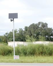 A Flock Safety camera sits along U.S. Highway 90 on the east side of Live Oak on Tuesday. (JAMIE WACHTER/Lake City Reporter)