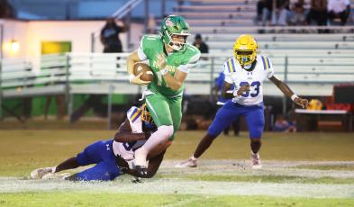 Suwannee quarterback Haigen Johnson tries to escape pressure from the Palatka defense last Friday. (PAUL BUCHANAN/Lake City Reporter)