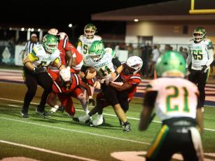 Suwannee quarterback Haigen Johnson is tackled by a Wakulla defender on Friday. (PAUL BUCHANAN/Lake City Reporter)