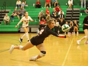 Fort White setter Macie MacLaren dives to defend a shot against Suwannee on Aug. 25. (PAUL BUCHANAN/Lake City Reporter)