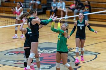Suwannee hitter Jaylin Nash (3) celebrates one of her kills with Makenzie Taylor (9) and her teammates during Tuesday's win over Lafayette. (JACK HOWDESHELL/Lake City Reporter)
