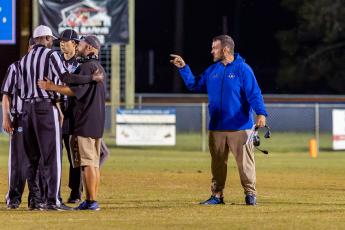Branford coach Will Dettor (right) and his assistant challenge the referees on a call during a game against Crescent City on Sept. 25. (JACK HOWDESHELL/Lake City Reporter)