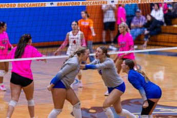Branford outside hitter Anabella Dicks (left) celebrates her kill with teammates Raelea Bradow (6) and Ava Alcorn (12) during Tuesday's win over Lafayette. (JACK HOWDESHELL/Lake City Reporter)