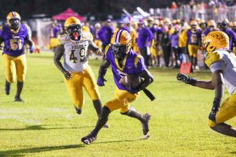Columbia receiver Kyren Caldwell splits the Yulee defense for one of his three touchdowns Friday night. (BRENT KUYKENDALL/Lake City Reporter)