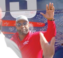 Republican gubernatorial candidate Byron Donalds waves to a crowd in Live Oak on a bus tour stop Tuesday at the Elks Lodge in downtown Live Oak. (JAMIE WACHTER/Lake City Reporter)