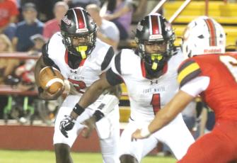 Fort White’s Marvion Wallace follows running back John’l Lawson on the wildcat run in last week’s 34-32 loss to Baker County. (MORGAN MCMULLEN/Lake City Reporter)