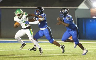 Suwannee running back Travon Fead can’t find any running room as he’s tackled by Godby safety Jayse Doss on Friday night. (PAUL BUCHANAN/Lake City Reporter)