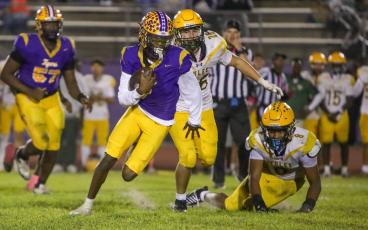 Columbia quarterback Amari Green scrambles through the Yulee defense for a gain during last Friday’s 42-0 win. (BRENT KUYKENDALL/Lake City Reporter)