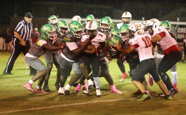 Suwannee defensive tackle Jakari Brown wraps up Baker County running back Gary Mosely on Oct. 8. (PAUL BUCHANAN/Lake City Reporter)