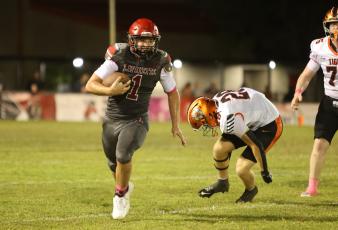 Lafayette quarterback Trevor Byrd turns the corner of the Trenton of the defense for a gain last Friday. (PAUL BUCHANAN/Lake City Reporter)