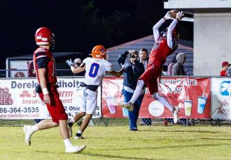Lafayette receiver Coy Plunkett makes a leaping catch in the back of the end zone for a touchdown in front of Branford defender Colby Beard on Friday. (JACK HOWDESHELL/Lake City Reporter)