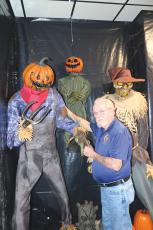 American Legion Post 57 Commander Bill Huggins shows off some of the characters that will greet children for a Kids Safe Halloween event on Saturday. (TONY BRITT/Lake City Reporter)