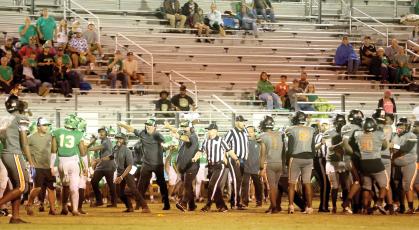 Suwannee head coach Kyler Hall and assistants PJ Davis, Kendrick Carter and Brian Wilder try to get the Bulldogs, including Jadayce Jones (13) to get away after a skirmish broke out late in the third quarter Friday against Zarephath Academy. Officials try to keep the Zarephath players separated. The game ended moments later when the Eagles decided to quit after having one player previously ejected as well. (PAUL BUCHANAN/Lake City Reporter)