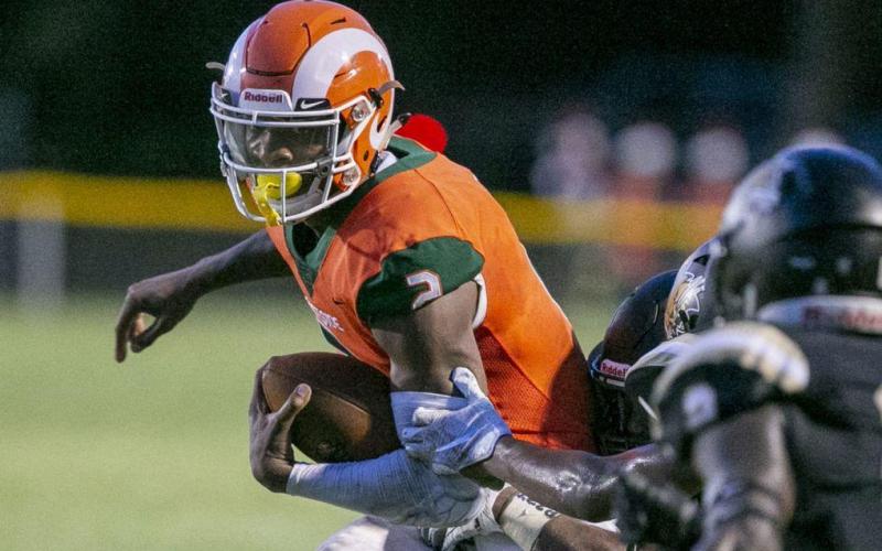 Eastside High quarterback Anthony Richardson evades a Buchholz defender during their game earlier this season at Citizens Field. (ALAN YOUNGBLOOD/TNS)