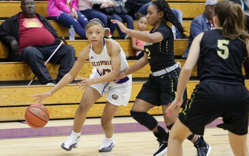 Columbia guard Taylor Ivery looks to drive by Lincoln’s Erin Turral on Dec. 13, 2019. (BRENT KUYKENDALL/Lake City Reporter)