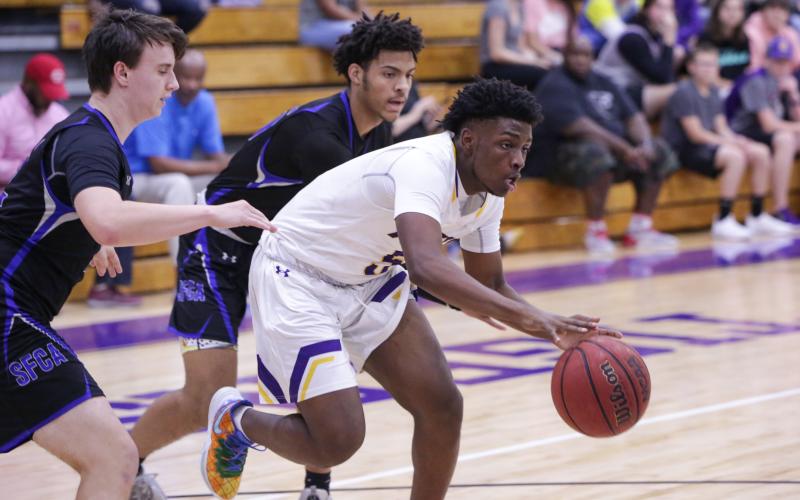 Columbia guard Darrien Jones drives through Saint Francis Catholic's defense on Tuesday night. (BRENT KUYKENDALL/Lake City Reporter)