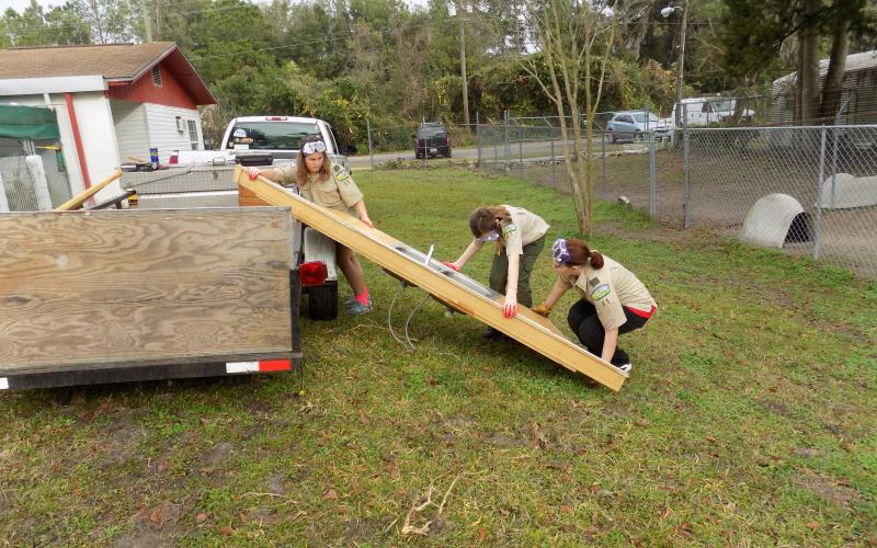 Harmony Parker, Marion Wolff and Erica Cummings gently unload a sink that would be installed in the refurbished food preparation area for the Lake City Humane Society. (STEPHANIE CHAMBERS-WOLFF/Special to the Reporter)