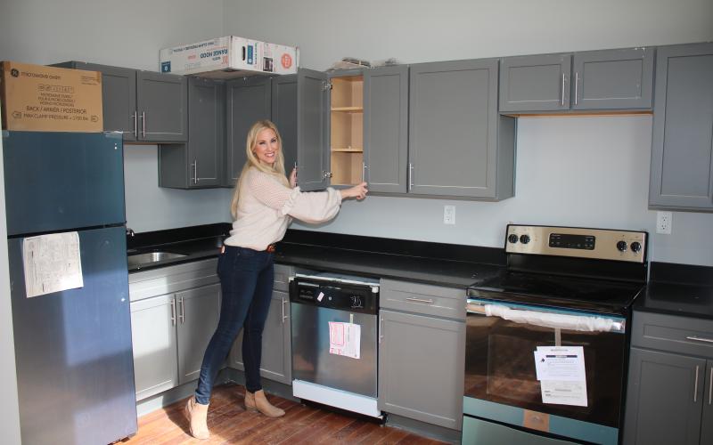 Dennille Decker, Blanche operations director, looks over cabinets in the kitchen area of a short-term Blanche Hotel unit. (TONY BRITT/Lake City Reporter)
