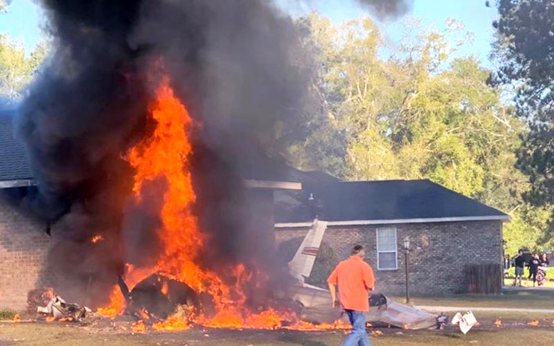 A single-engine plane is seen in flames after crashing into a home in Cannon Creek Airpark Saturday morning. (Photo courtesy of AMY BROWN/Facebook)