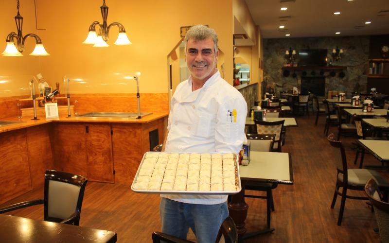Abraham Farajian with a tray of baklava. (MICHAEL PHILIPS/Lake City Reporter)