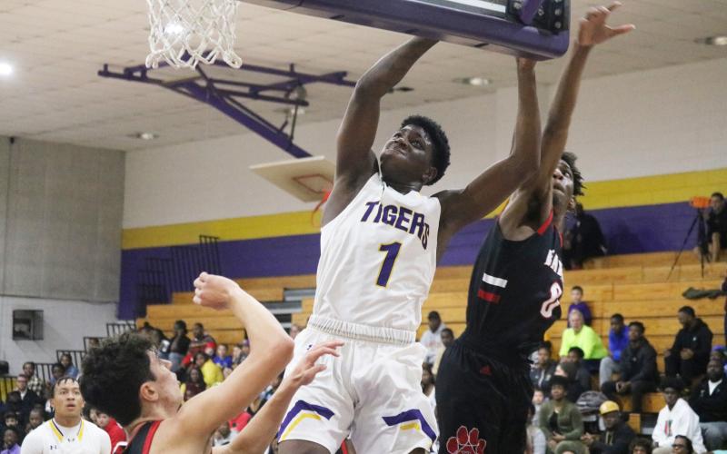Columbia forward Marcus Peterson flies to the basket for a layup against Baker County on Friday night. (JORDAN KROEGER/Lake City Reporter)