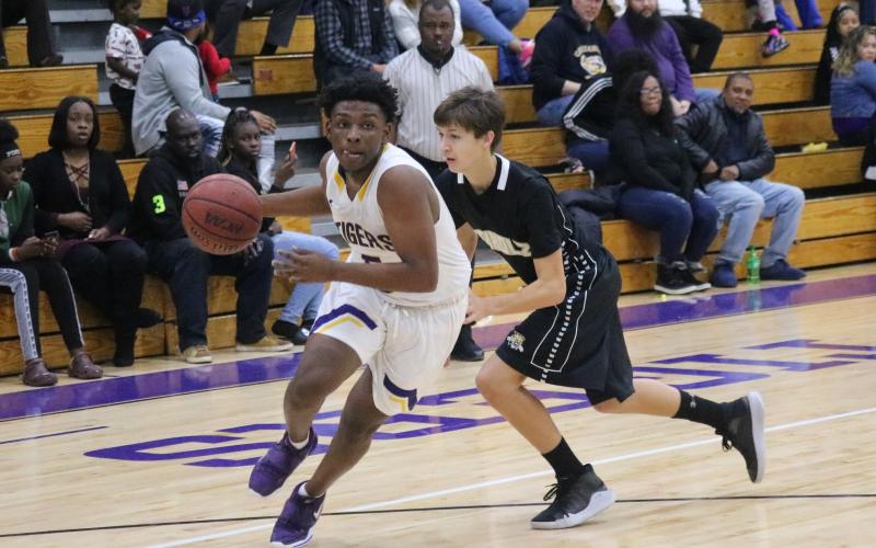 Columbia point guard Darrien Jones drives by Buchholz on Tuesday night. (JORDAN KROEGER/Lake City Reporter)