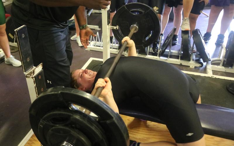 Columbia’s Reece Chasteen bench presses 190 pounds to break her own school record in the 199-pound weight class at the District 2-2A meet on Friday. (JORDAN KROEGER/Lake City Reporter)