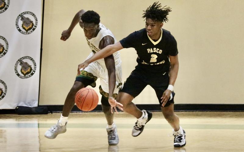 FGC forward Nate Henderson knocks the ball away from Pasco-Hernando forward Antonio Tucker on Saturday. (JORDAN KROEGER/Lake City Reporter)