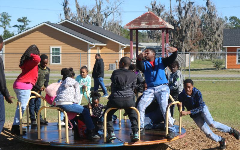 A youngster spins a group of friends at Annie Mattox Park on Monday during the Passion Through Action group’s Martin Luther King Jr. celebration. (TONY BRITT/Lake City Reporter)
