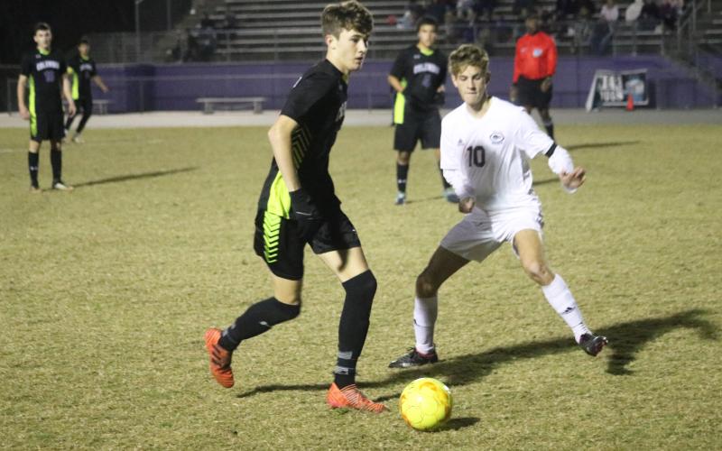 Columbia’s Max Bavar dribbles past Chiles’ Robbie Allman on Tuesday night. (JORDAN KROEGER/Lake City Reporter)
