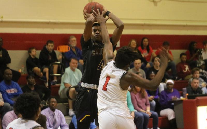 Columbia guard Kenney Gaines pulls up for a jumper over Santa Fe’s Jamir Harris on Friday night in Alachua. (ZACH ABOLVERDI/Lake City Reporter)