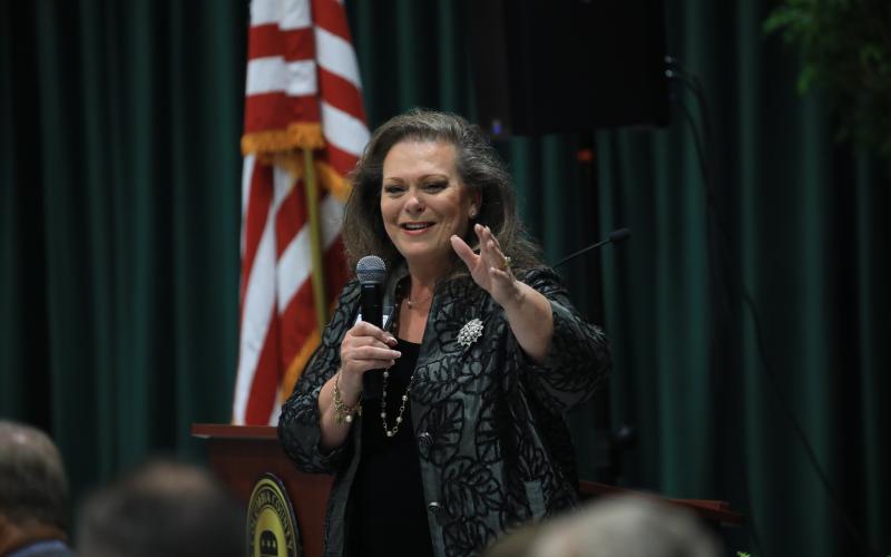 Columbia County Republican Party Event Chair Kimi Roberts, who was instrumental in getting Huckabee to come here, addresses the crowd. (CAMERON VINING/Special to the Reporter)